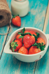 High angle view of strawberries in bowl on table