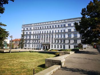 Buildings against clear blue sky in city