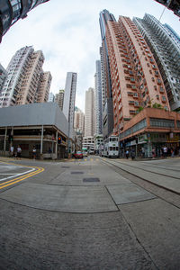 View of city street and buildings against sky