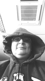 Portrait of young man wearing sunglasses at home