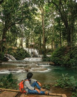 Man sitting on riverbank