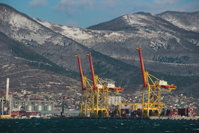 Scenic view of sea by mountains against sky