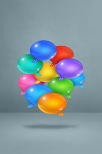 Multi colored balloons against blue background