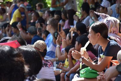 Spectators sitting in stadium while watching event