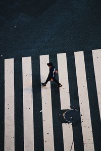 High angle view of man crossing road