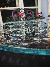 Close-up of glass window on table