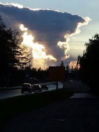 Cars on road at sunset