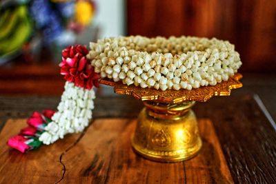 Close-up of floral garland on golden stand