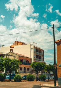 Street and buildings against sky