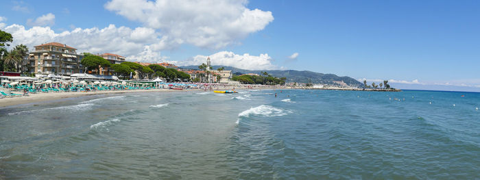 Panoramic view of sea and buildings against sky