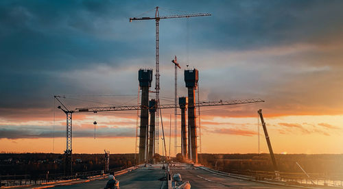 View of cranes at sunset