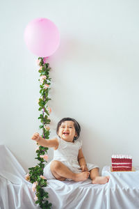 Cute boy with balloons at home
