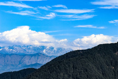 Scenic view of mountains against cloudy sky