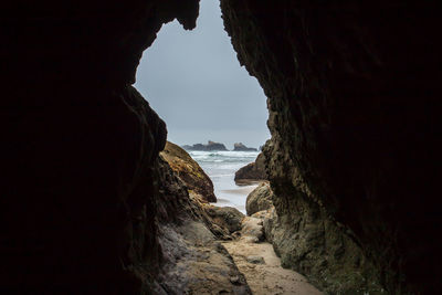 Scenic view of sea seen through cave