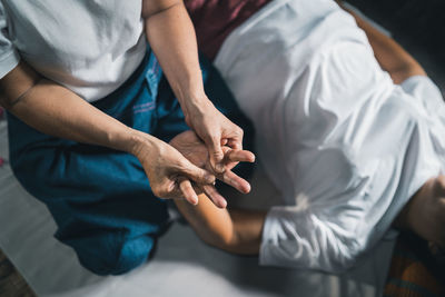 Midsection of man holding hands