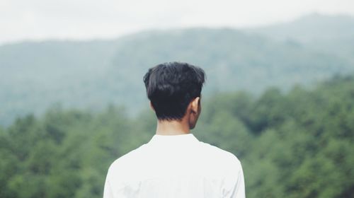 A man enjoying the view from the top of mountain