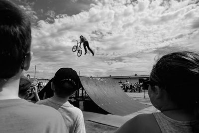 Portrait of man jumping against sky