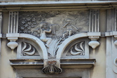 Low angle view of statue against building