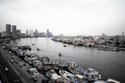 High angle view of river by buildings in city against sky