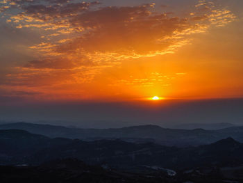 Scenic view of dramatic sky during sunset