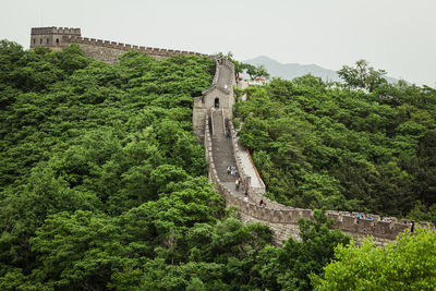 Low angle view of castle on mountain against sky