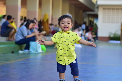 Full length portrait of cute boy smiling