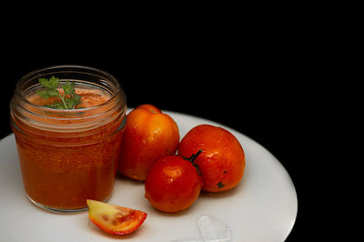 Close-up of fruits in glass jar on table