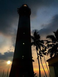 Low angle view of lighthouse against sky at dusk