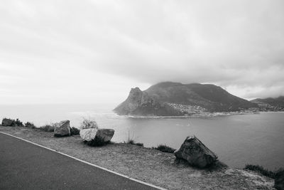 Scenic view of sea and mountains against sky
