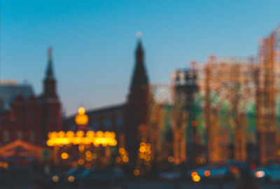 Defocused image of city lit up at dusk