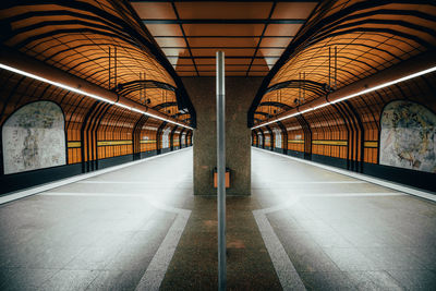 Empty illuminated railroad station platform