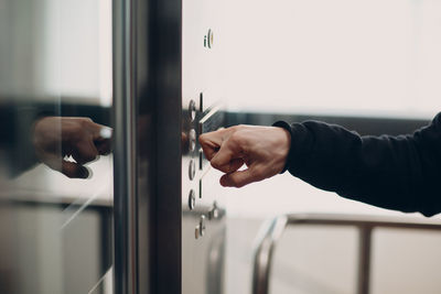 Close-up of man hand on door