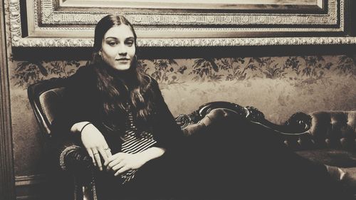 Portrait of young woman sitting on bench