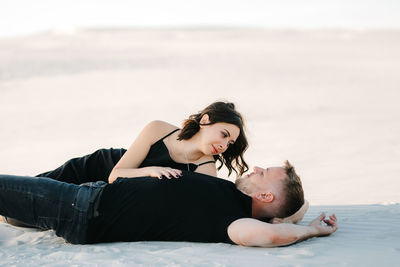 Young woman lying on beach