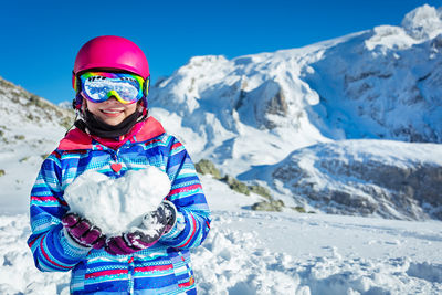 Rear view of woman skiing on snowcapped mountain