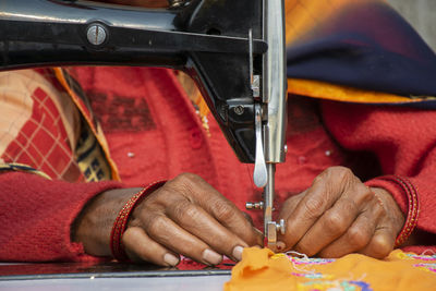 Close-up of hands working with sewing machine