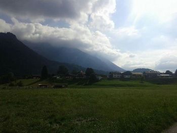 Scenic view of landscape against cloudy sky