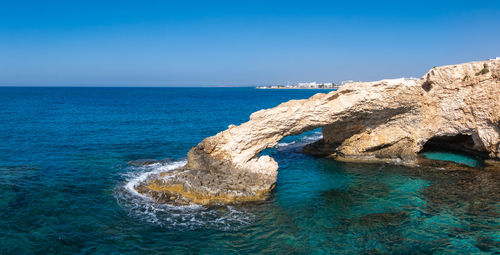 Scenic view of sea against clear blue sky