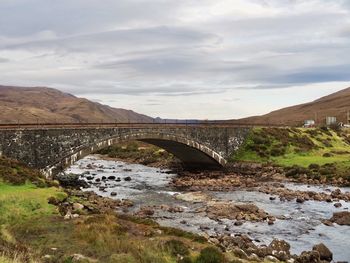 Bridge over river against sky