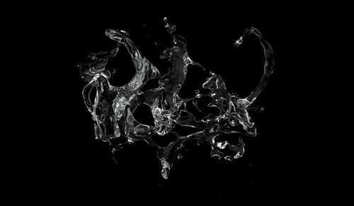 Close-up of water splashing against black background