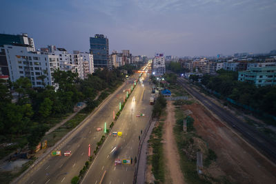 High angle view of traffic on road amidst buildings in city