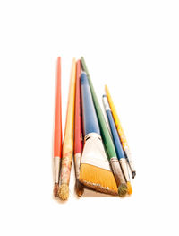 Close-up of multi colored pencils against white background