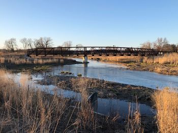 Bridge over river against clear sky
