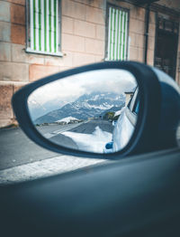 Reflection of car on side-view mirror