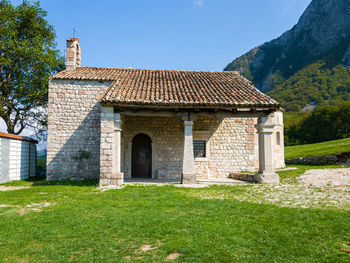 Building on field against clear sky