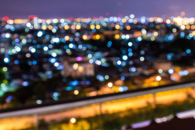 Defocused image of illuminated city at night