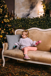 Little child girl having fun and relaxing at home. xmas and new year concept