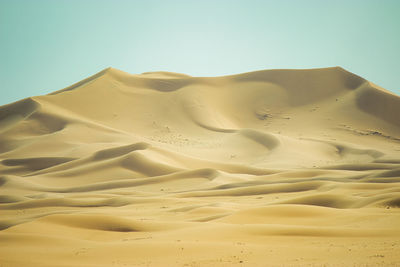 Scenic view of desert against clear sky