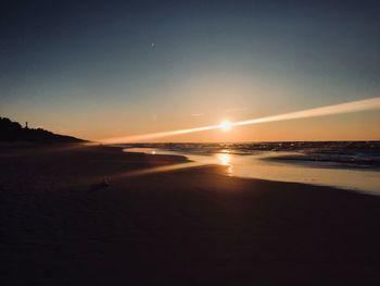 Scenic view of beach against sky during sunset