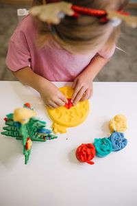 Midsection of woman holding food on table